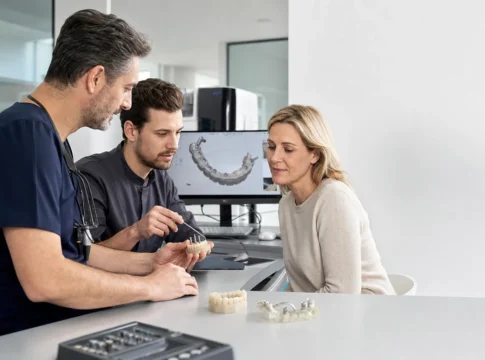 Dental team reviewing an All-on-6 implant-supported bridge plan with a patient
